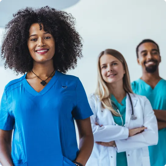 healthcare worker smiling while standing in a medical office